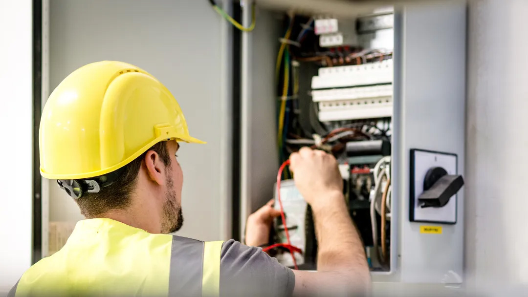 Electrician working on electrical panel