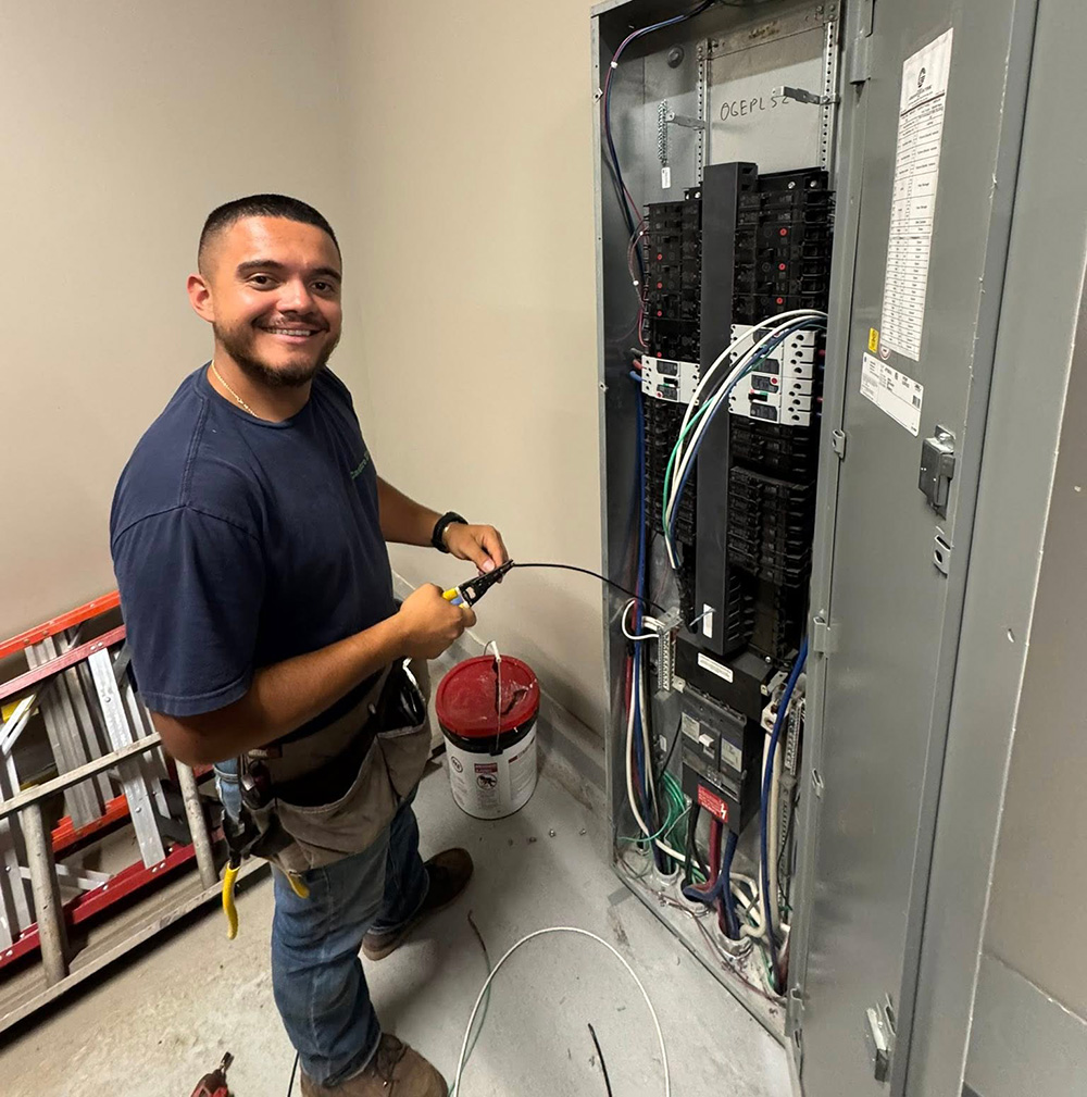Electrician working on circuit panel